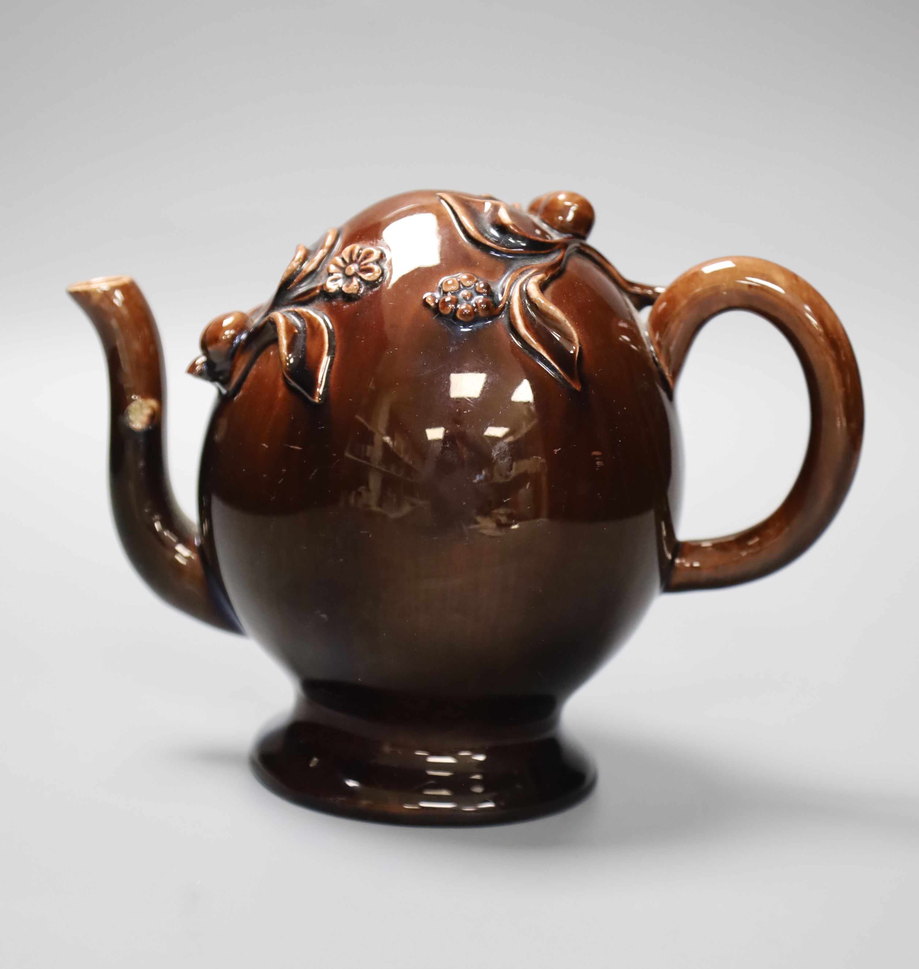 A small Brameld Cadogan teapot, relief moulded and gilded over a brown glaze, impressed mark, height 15cm, minor spout chip